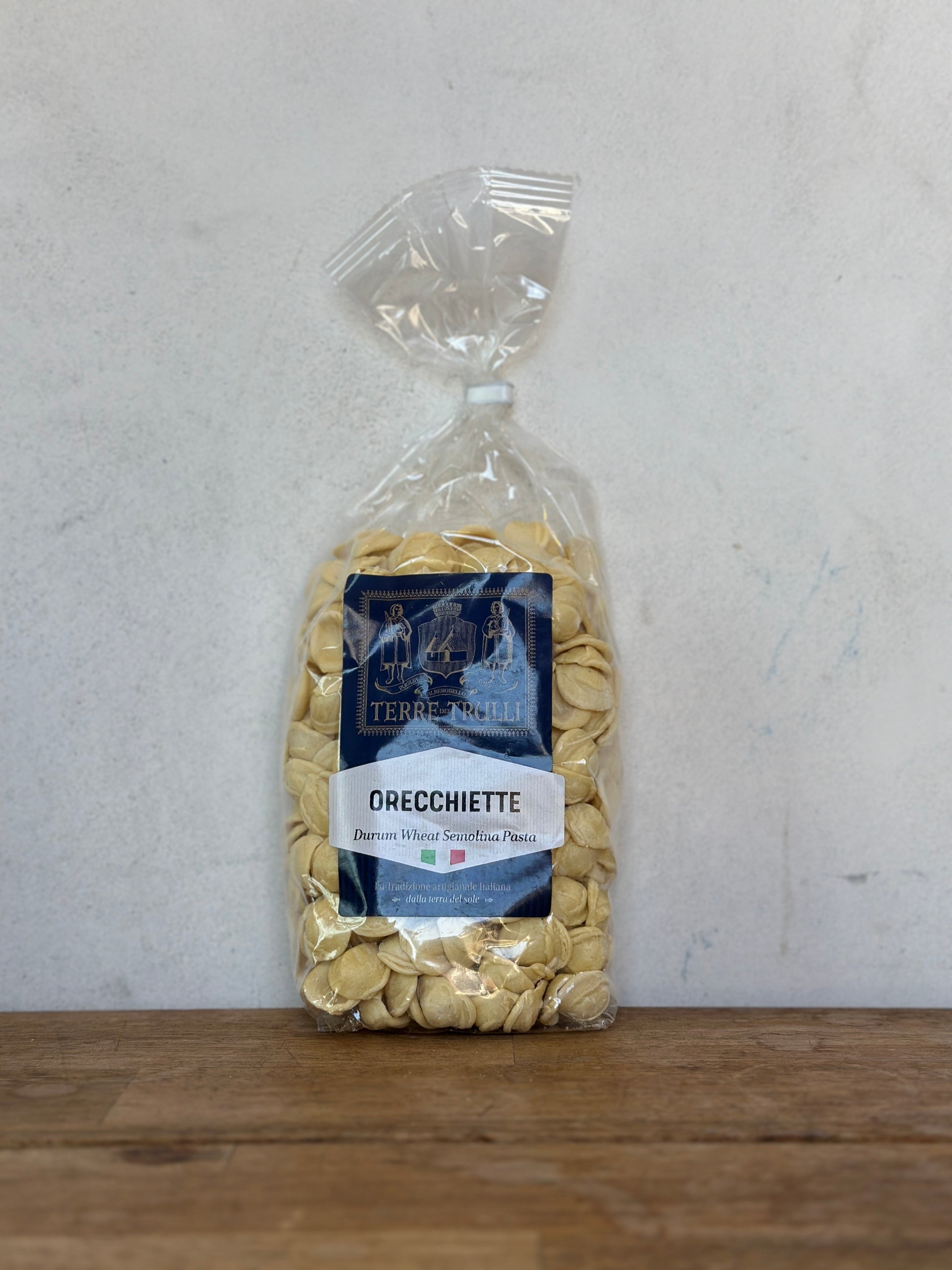 Bag of Orecchiette pasta with a label on a gray background