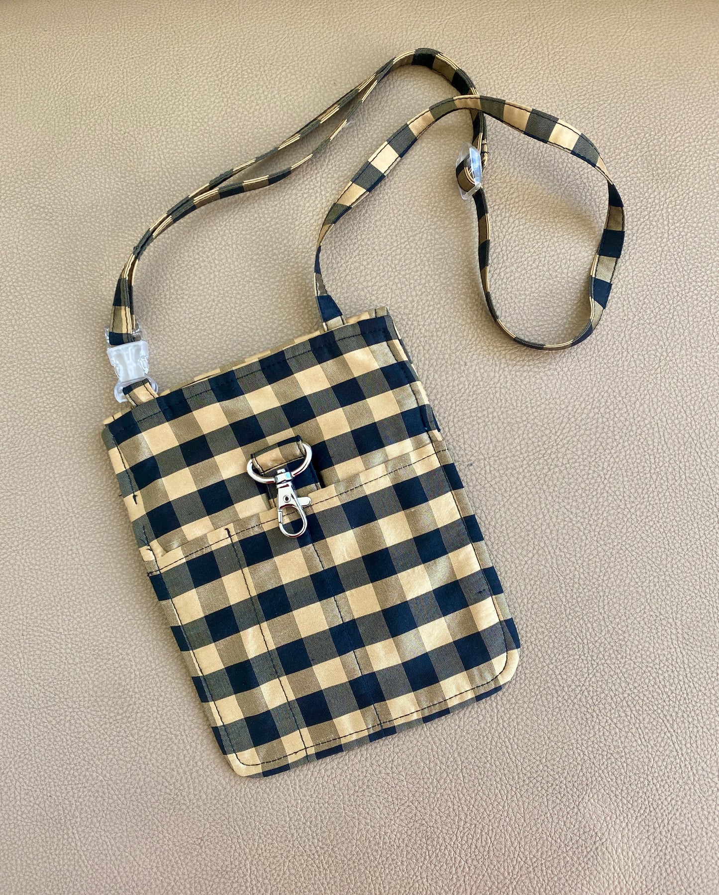 COA travel sling bag in gingham black and gold