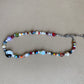 multi-color beaded necklace with a chunky yin-yang charm as the focal piece of the necklace