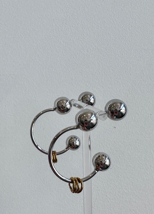 Metal pierced earring with brass detail