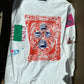 white cotton long sleeve shirt with hand printed collage work down the front and sleeves the left sleeve has a sketch of a lighter with a neon pink flame, closer to the shoulder is the word venus in all caps split by a green rectangle with a white sketch of a hand, palm up